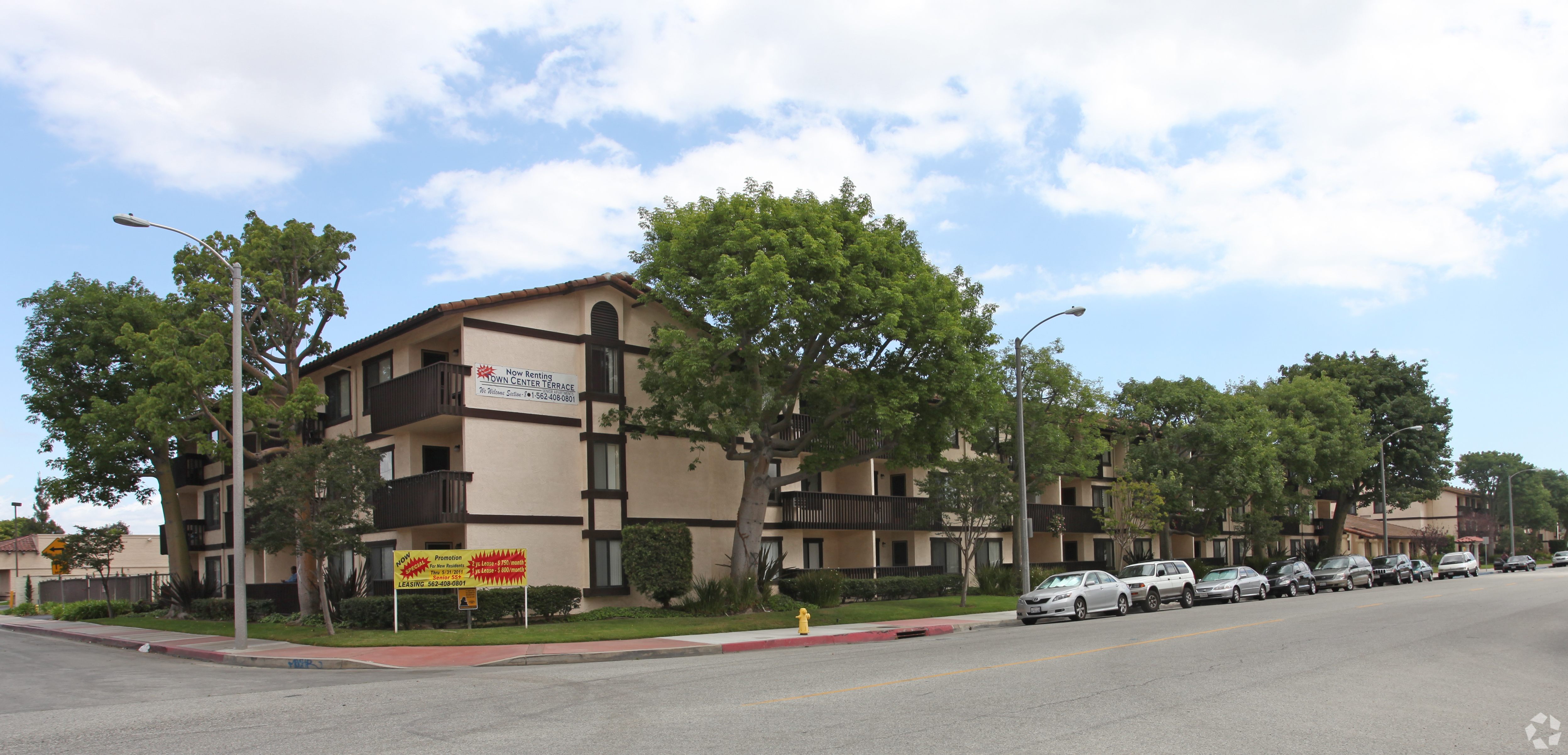 Apartment building with a yellow sign in front of it.